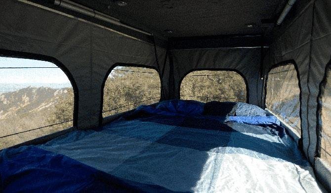 Het bed in de pop-up van de Del Mar camper van Escape Campervans
